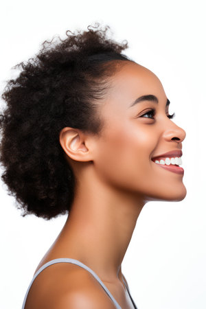Portrait of beautiful young african american woman smiling, isolated on white backgroundの素材