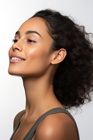 beautiful smiling african american young woman, isolated on greyの素材