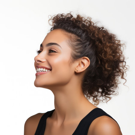 Beautiful young african american woman with curly hair on white backgroundの素材