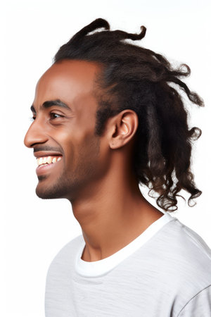 Closeup portrait of a smiling young african american man, isolated on white backgroundの素材