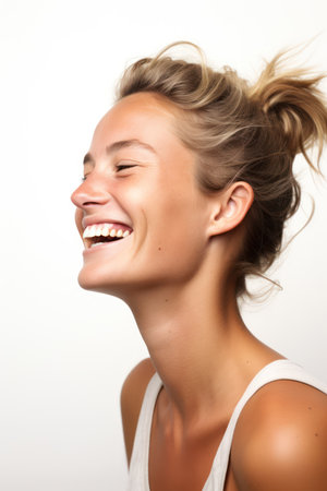 Portrait of a beautiful young woman laughing with her hair in the windの素材