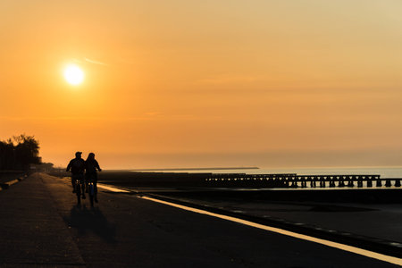 Two cyclists at sunriseの写真素材