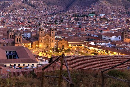 Cityscape of Cusco, Peru at sunset. as the street lights turned on and the sun was leaving us for the day. Many red roofs of the city of Cuscoの写真素材