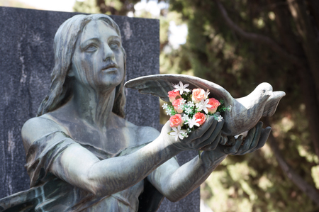 statue of angel with birdの写真素材