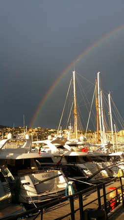 rainbow over the Old Port of Genoa In Italyの写真素材