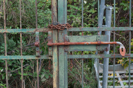 rusty iron gate with chain