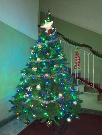 christmas tree with lights and colorful decorationsの写真素材