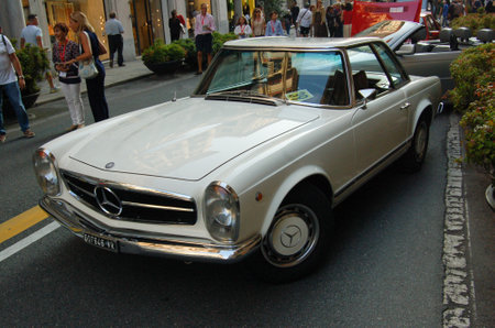 vintage car at a parade through the city streetsの写真素材