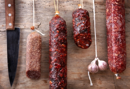 various hanging salami sausagesの写真素材