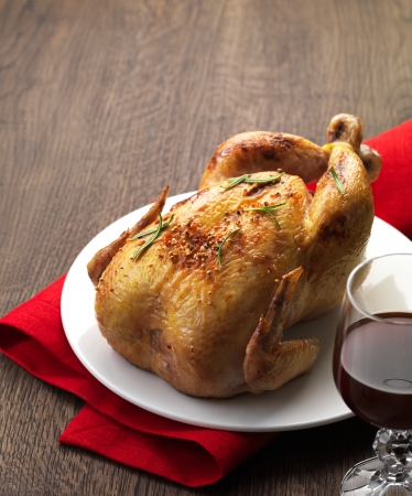 Roast chicken and glass of wineの写真素材