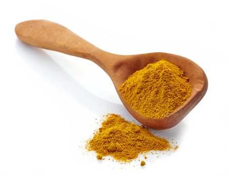 spoon of curry on a white backgroundの写真素材