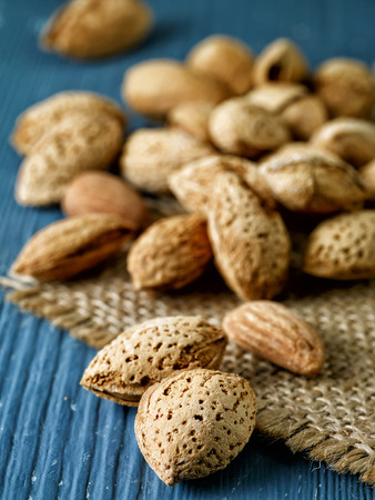 roasted almond nuts on wooden tableの写真素材