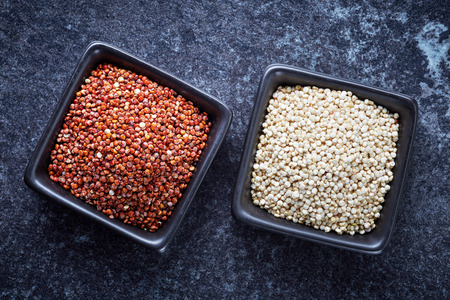 bowls of healthy red and white quinoa seedsの写真素材