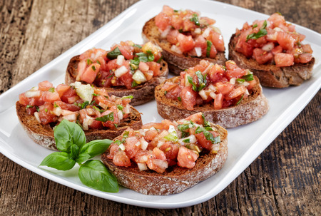 plate of bruschettas on wooden tableの写真素材