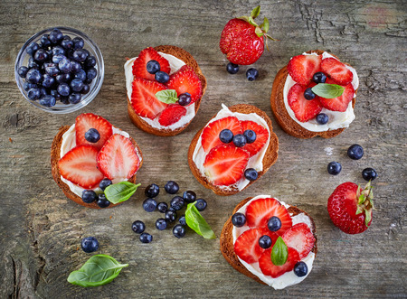 toasted bread slices with berries and cream cheeseの写真素材