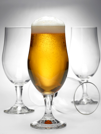 glass of beer and empty glassesの写真素材