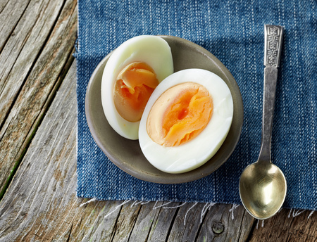 boiled egg on wooden table, top viewの写真素材