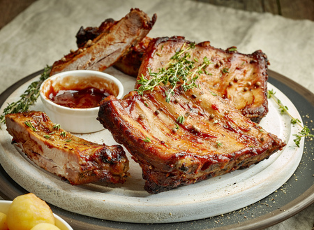 grilled pork ribs on white cutting boardの写真素材
