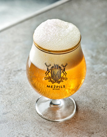 Riga, Latvia, 09.october 2016 - Glass of popular latvian beer Mezpils on grey restaurant table