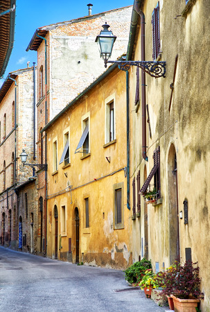 Beautiful narrow street of historic tuscan city Volterra, Italyの写真素材