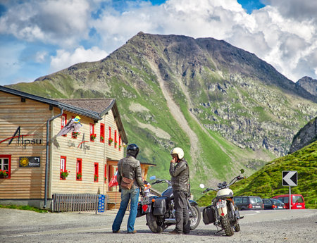 Furka Pass, Switzerland - 17 JULY, 2017: Two bikers and view of swiss Alps, Switzerlandのeditorial素材