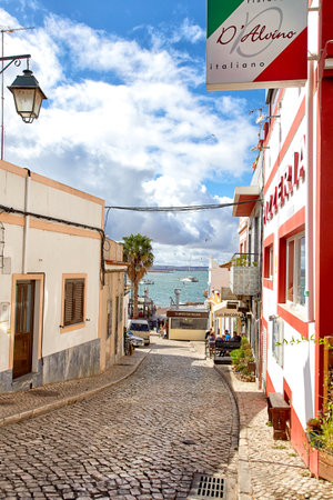 Alvor, Portugal - October 18, 2017: Beautiful narrow street of portuguese fisherman village Alvor in Algarve region of Portugalのeditorial素材