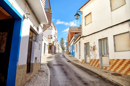 Alvor, Portugal - October 18, 2017: Beautiful narrow street of portuguese fisherman village Alvor in Algarve region of Portugalのeditorial素材