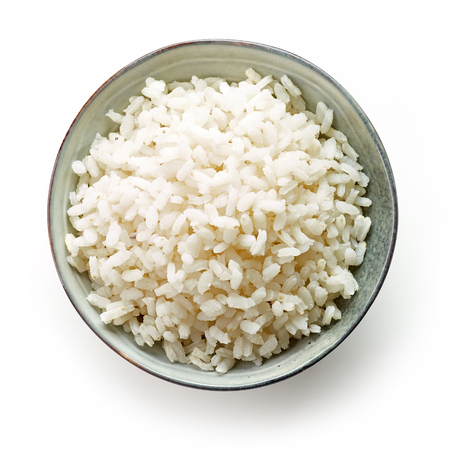 bowl of boiled round rice isolated on white background, top viewの写真素材