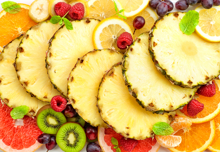 various colorful sliced fruit backgroundの写真素材