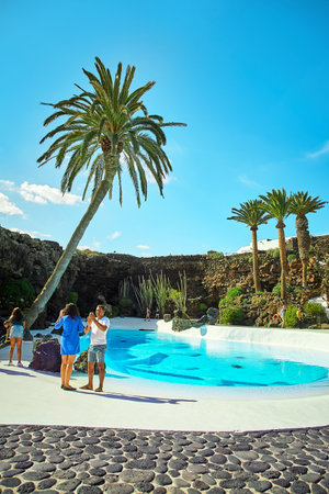 Lanzarote, Spain - DECEMBER 02, 2017: Tourists are walking and taking pictures in Jameos del Agua garden in Lanzarote, Canary Islands, Spainのeditorial素材
