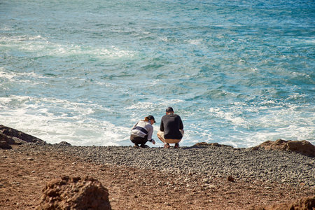 Lanzarote, Spain - DECEMBER 03, 2017: Tourists enjoing beautiful view of Atlantic ocean in El Golfo, Lanzarote island, Canaries, Spainのeditorial素材