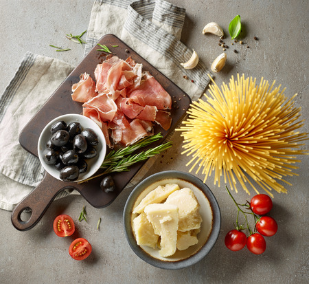 healthy italian food ingredients on grey kitchen table, top viewの写真素材