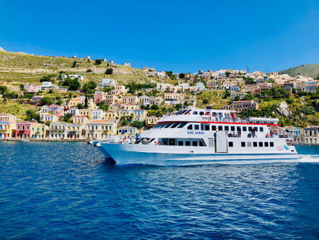 Simi island, Greece - MAY 13, 2019: beautiful view from the sea on colorful houses on rocks on Greek island Simi (Symi), Dodecanesseのeditorial素材