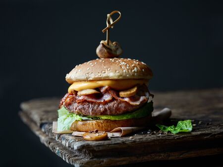 fresh tasty burger on old dark wooden tableの写真素材