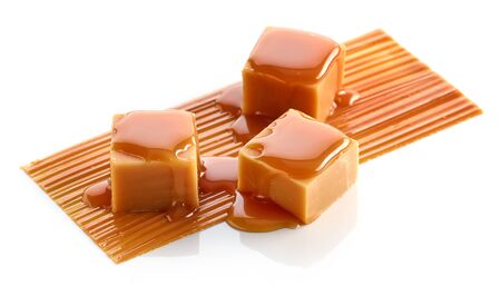 Composition of caramel candies isolated on whiteの写真素材