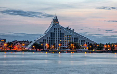 Riga, LATVIA - SEPTEMBER 11, 2020: night view of Latvian National library on the bank of the Daugava riverのeditorial素材