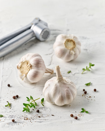 composition of garlic and spices on white kitchen tableの写真素材