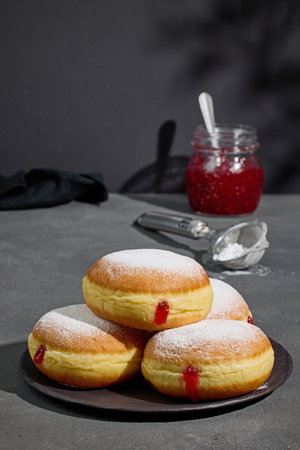 plate of jelly donuts on grey backgroundの写真素材