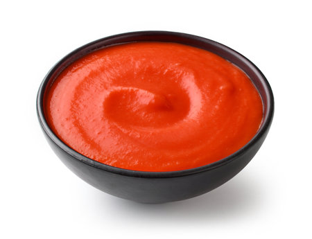 bowl of red tomato sauce ketchup isolated on white backgroundの写真素材