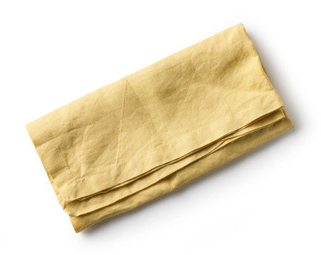 yellow folded cotton napkin isolated on white background, top viewの写真素材