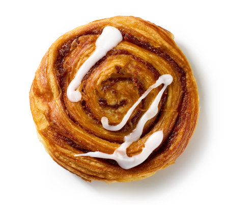 freshly baked sweet cinnamon roll isolated on white background, top viewの写真素材
