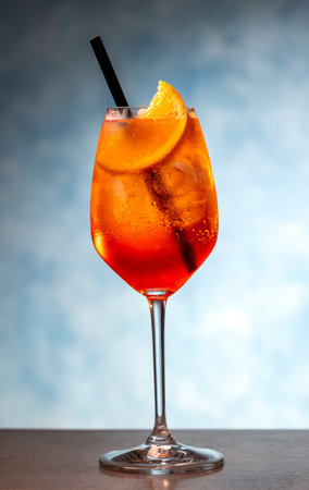 Closeup of aperol spritz cocktail in wineglass on blue backgroundの写真素材