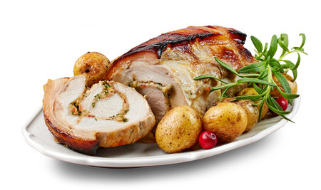 roast pork with potatoes isolated on white backgroundの写真素材