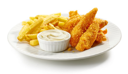 plate of french fries and chicken nuggets isolated on white backgroundの写真素材