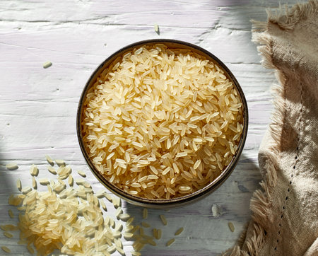 bowl of raw rice on white table, top viewの写真素材