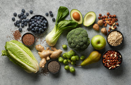 various fresh raw food ingredients on grey table, top view, Healthy food clean eating selection: fruit, vegetable, seeds, superfood, cereals, leaf vegetable on gray concrete background copy spaceの写真素材