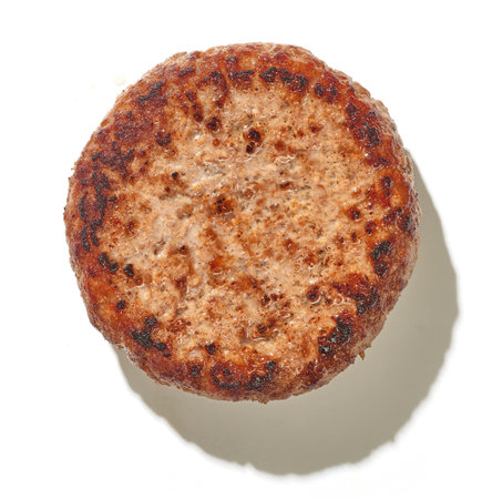 freshly grilled burger meat isolated on white background, top viewの写真素材