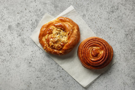 freshly baked sweet bread rolls on grey table, top viewの写真素材