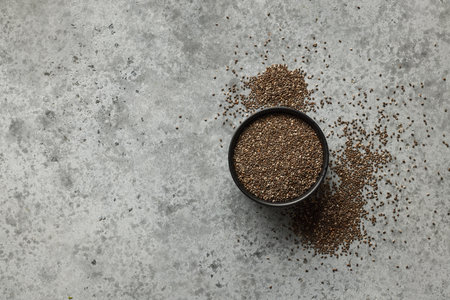 bowl of chia seeds on grey table, top viewの写真素材