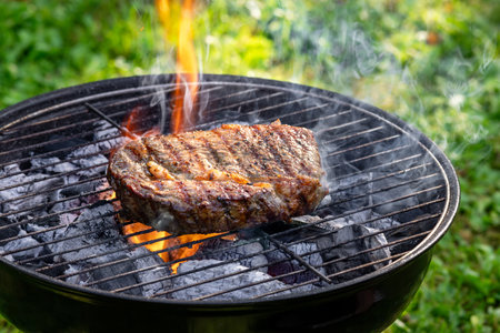 beef steak grilling on charcoal grillの写真素材